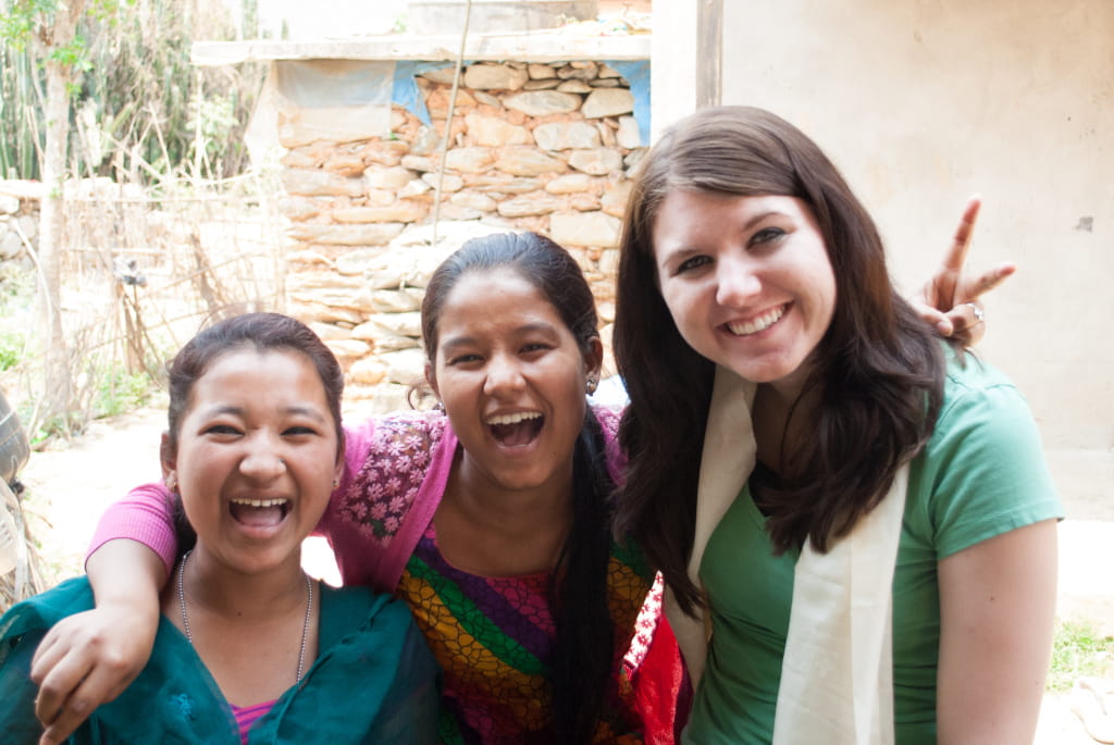 One Caucasian and two Nepalese women posing in Kathmandu.