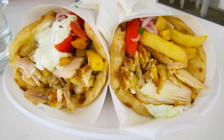 Pita stuffed with slices of roasted meat or veggies, tomatoes, onions, lettuce, tzatziki sauce, and french fries - Pic by Jackie & Justin from Life Of Doing