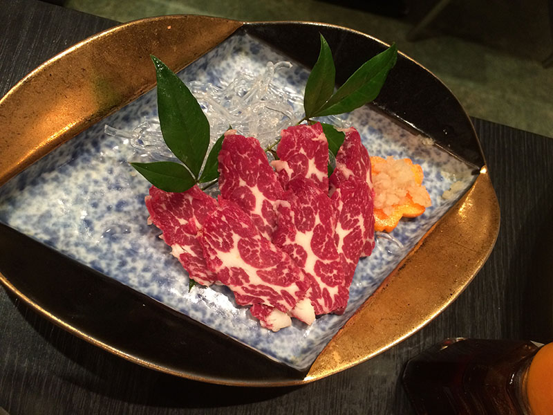 Basashi, Raw Horse Meat Sashimi in Japan on  square plate.