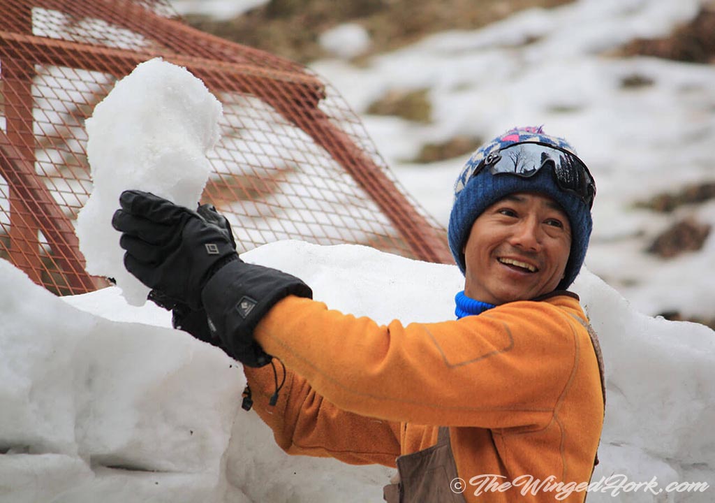 Tashi working on constructing the igloo - Pic by Abby from TheWingedFork