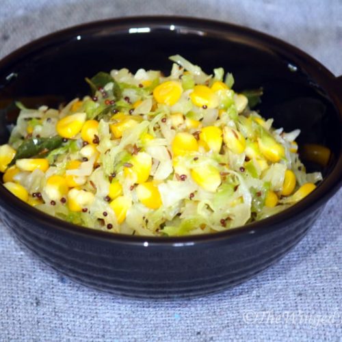 Corn and cabbage sabzi (veggies) in a black pot.