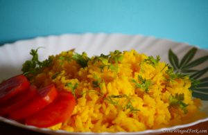 Rice served with coriander and tomatoes.