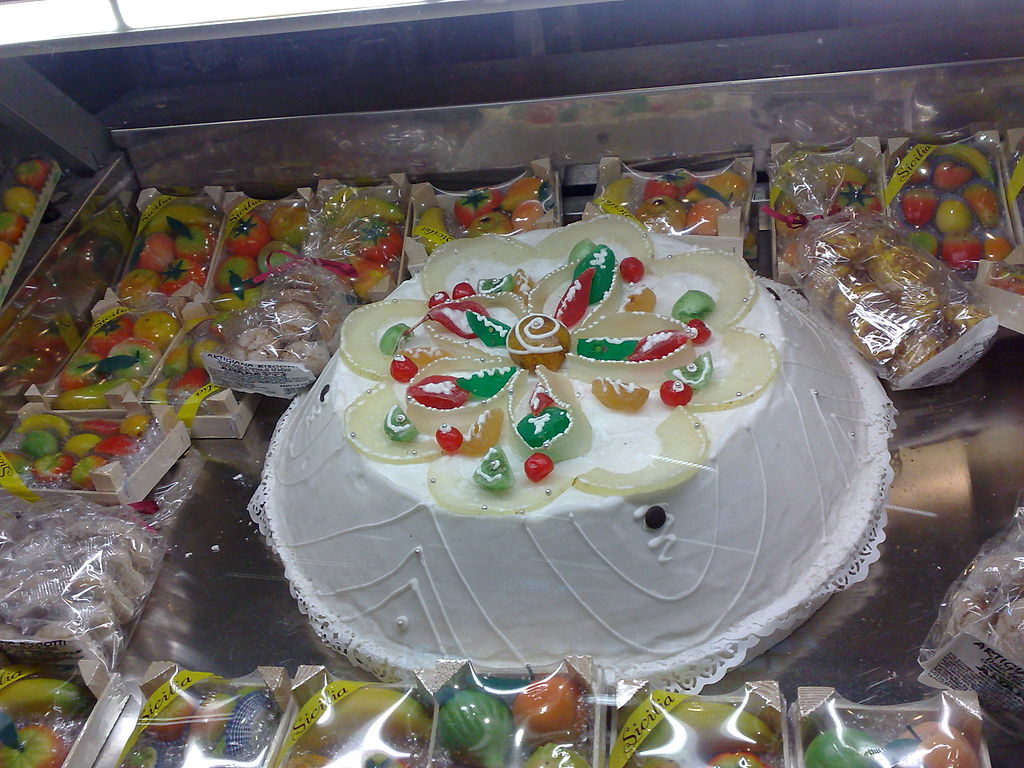 Wiki image of the Cassata Siciliana surrounded by marzipan fruits.