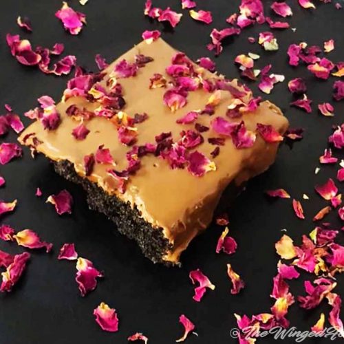 Chocolate brownie decorated with rose petals and served.