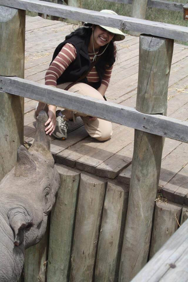 Girl(Sarah) touching a rhino's horn in Kenya.