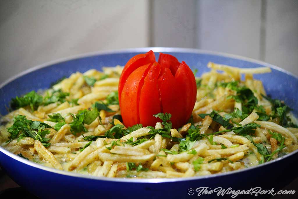 Serve egg salli with a sliced tomato.