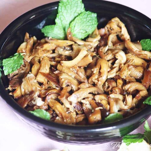 Buttery Oyster Mushroom is served in black kadhai.