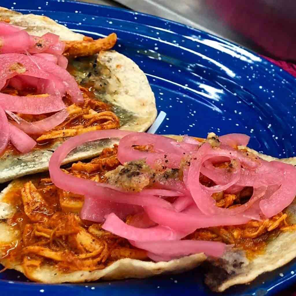 Tacos served with panuchos and onion.