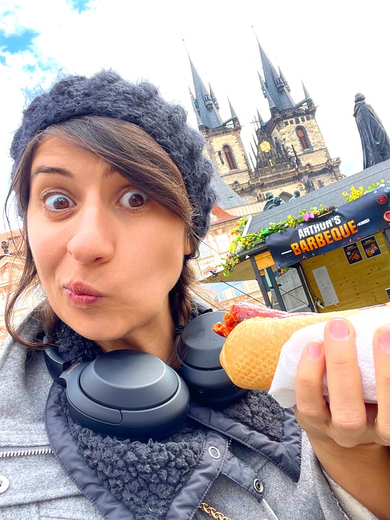 Lady eating mystery sausage in Prague.