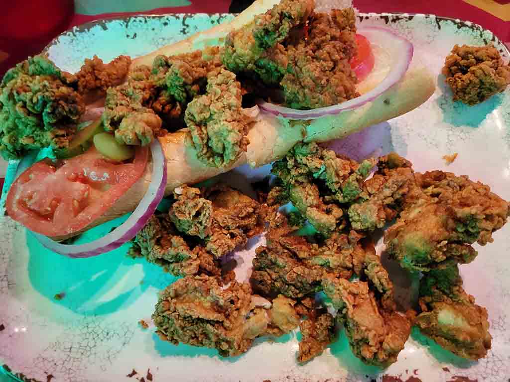 Fried Oysters and salad served on a plate.