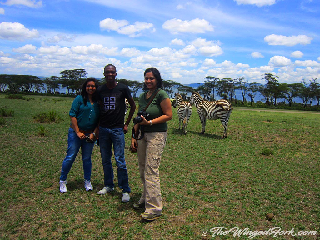 Blogger Sarah with friends and two zebra in the background.